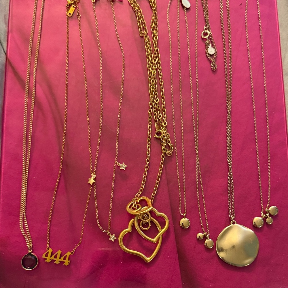 A lot of pendant, necklaces and gold tone